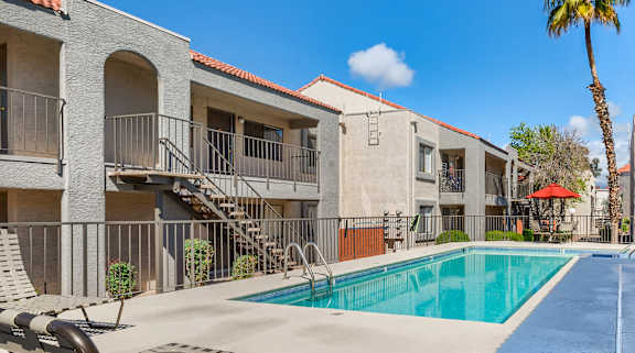 our apartments have a swimming pool and a patio with chairs