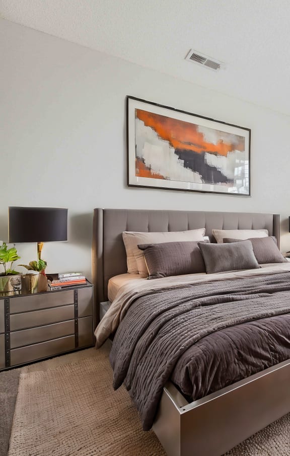 a bedroom with a bed and a large window