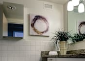 Thumbnail 1 of 4 - A white toilet sits in a bathroom with a brown and white tiled floor at Hampton Plaza Apartments, Towson, MD, 21286