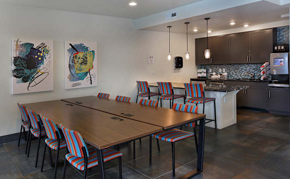A modern dining room with a wooden table and chairs. at Liberty Blvd Apartments - Saltlake City, UT Apartments, Apartments, Saltlake City, UT