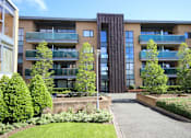 Thumbnail 9 of 9 - a view of a building with a pathway and trees