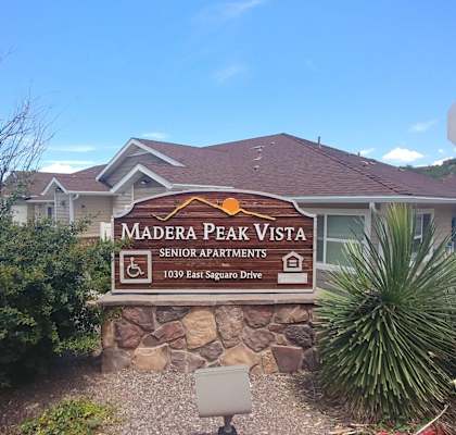 a picture of the madrone peak vista sign with a house in the background