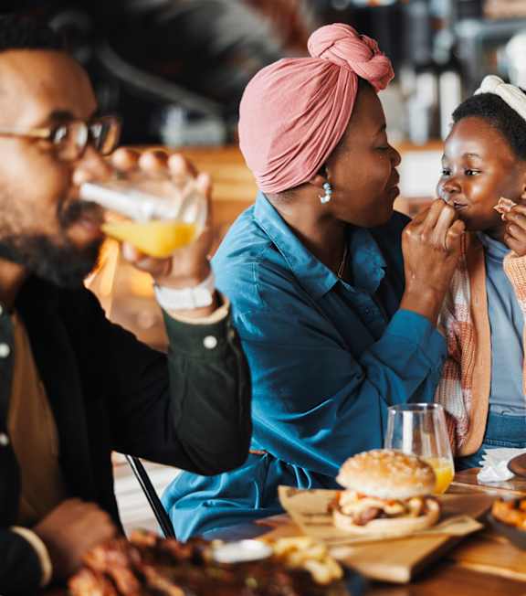 A group of people enjoying a meal together at a restaurant.
