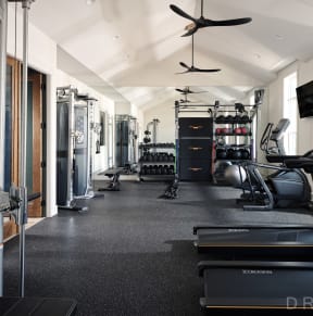 a woman running on a treadmill at the gym