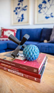 a stack of books with a blue couch in the background at Scouter's Mountain, Happy Valley, OR