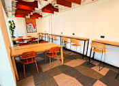 Thumbnail 10 of 16 - a dining room with tables and chairs and a counter