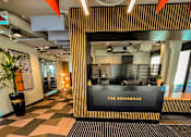 Thumbnail 8 of 16 - a lobby with a reception desk and a sign that reads the redesign
