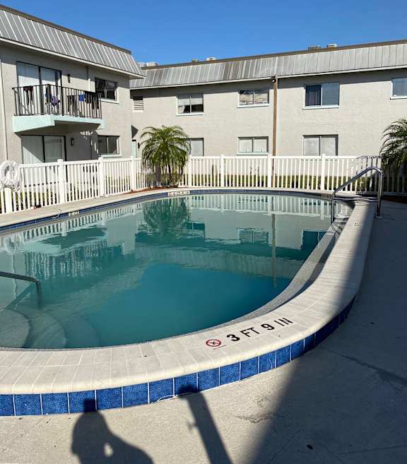 a swimming pool in front of a building