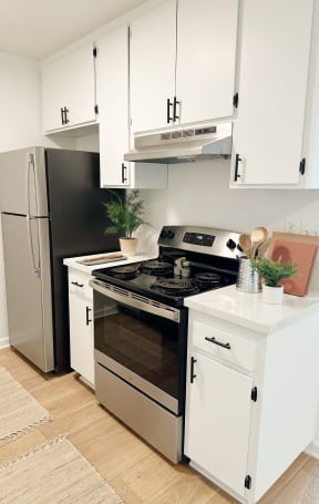 a kitchen with a sink and a refrigerator at Latitude Apartments at Mission Valley, California