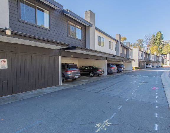 a parking lot with cars parked in front of a building