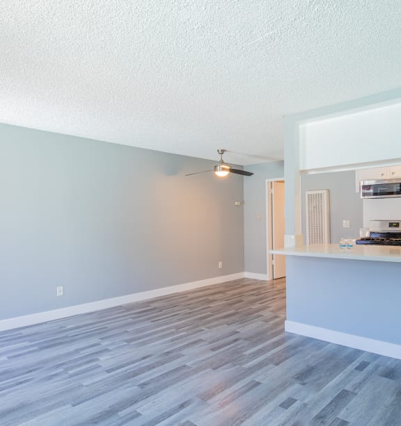 an open living room and kitchen with a counter top and