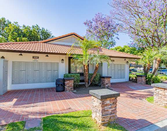 A house with a red tiled roof and a white garage door.