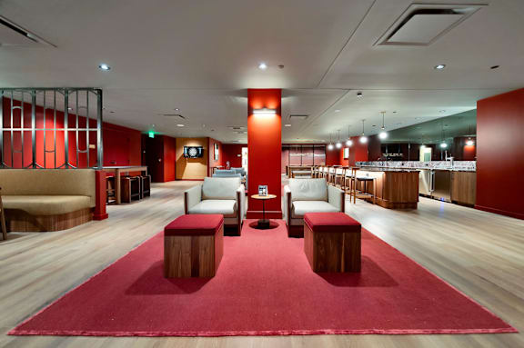 A red carpeted room with wooden floors and furniture. at 17 Market West, Philadelphia, PA 19103