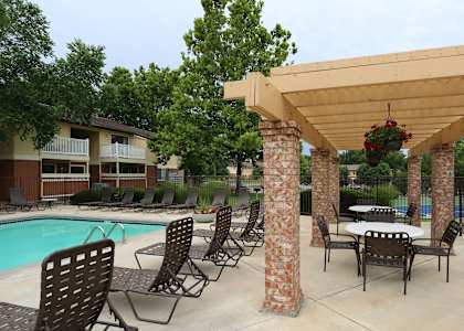 our apartments have a large pool and a patio with tables at Lodge of Overland Park Apartments, Overland Park , 66212