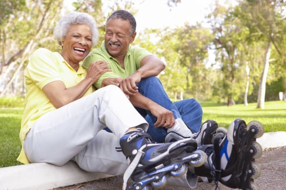 This is a photo of an older active couple roller blading.