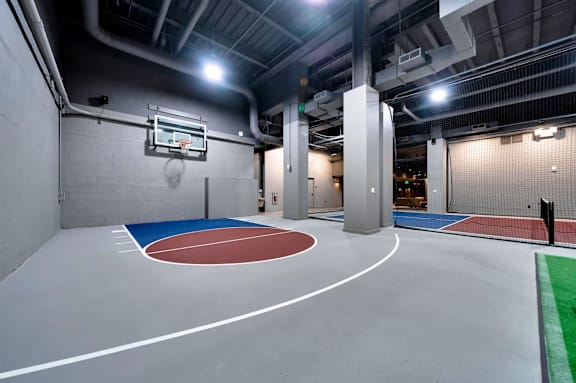 A basketball court is located in a large room with a basketball hoop on the wall. at 17 Market West, Philadelphia, PA 19103