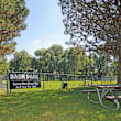 a park with a picnic table and a barra park sign