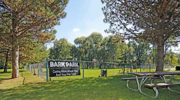 a park with a picnic table and a barra park sign