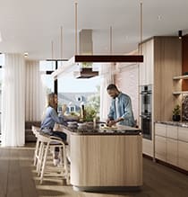 A man and a woman are sitting at a kitchen island.