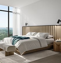 A bedroom with a large bed and a window overlooking a cityscape.