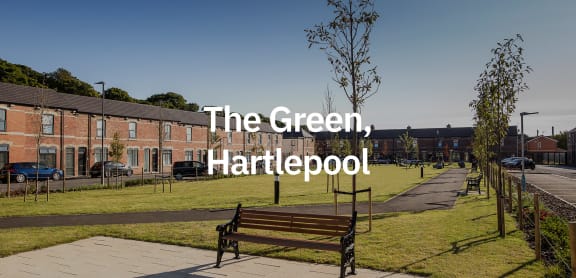 the green hattepoint in front of a park with a bench