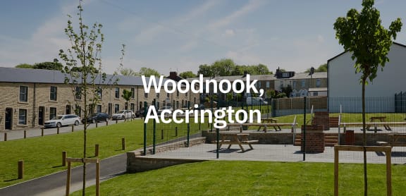 a view of a park with a playground and buildings