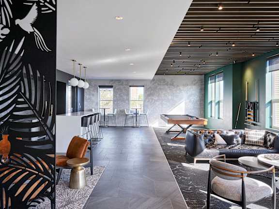 A living room with a black and white mural on the wall.