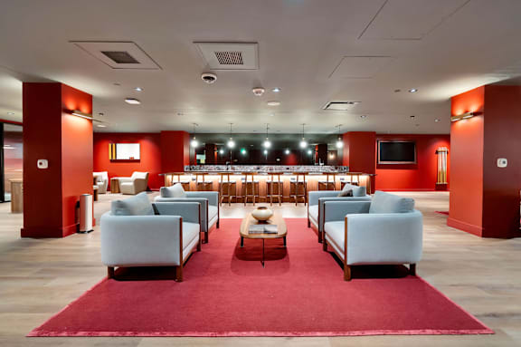 A large room with a red carpet and white chairs. at 17 Market West, Philadelphia, PA 19103