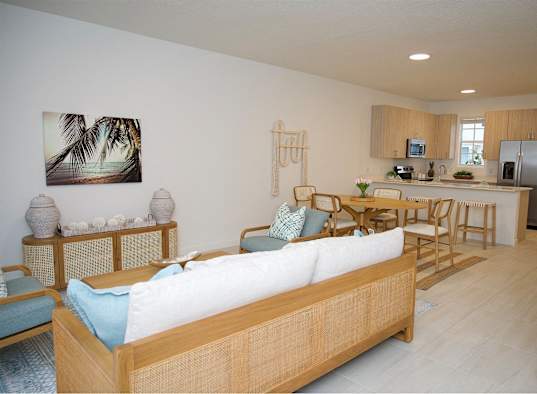 a living room with a couch and a table and a kitchen