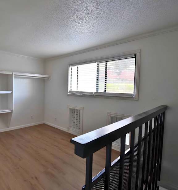 Empty room with white shelves and a window.
