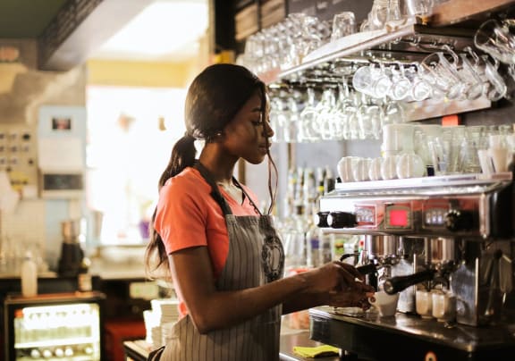 a bartender making a drink in a bar
