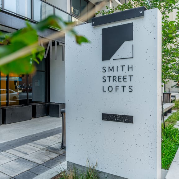 a sign in front of a building that says smith street lofts