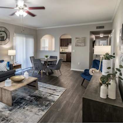 A living room with a grey couch and a wooden coffee table.