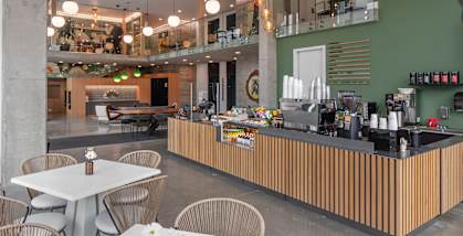 a view of a restaurant with tables and chairs and a bar