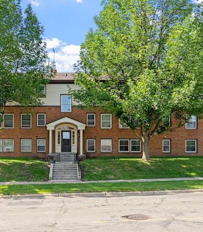 a red brick building with trees in front of it