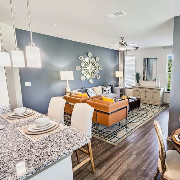 A modern dining room with a round table set for six.