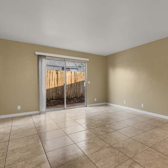 an open kitchen and living room with a counter and a ceiling fan at Cedar Park Apartments, Chico, CA, 95926