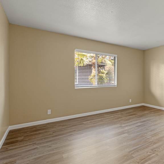 an empty kitchen with black cabinets and a counter top at Cedar Park Apartments, Chico, California