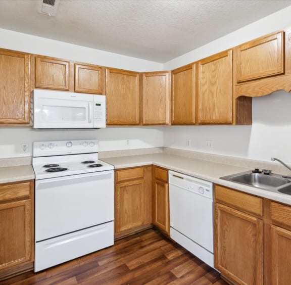 Kitchen With Wood-Style Flooring & Large Windows