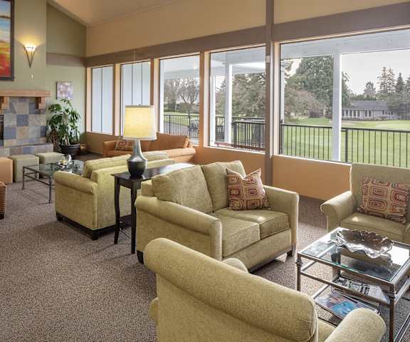 a living room with couches and chairs and a fireplace