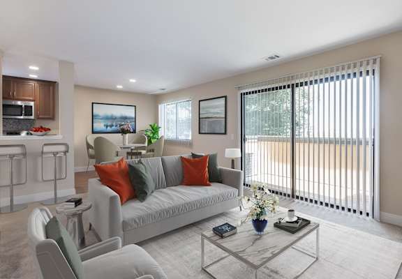 a living room with a couch and chairs and a table