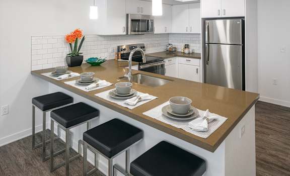Arc Central Apartments Model Kitchen with Appliances and Breakfast Bar