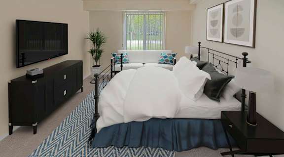 a bedroom with a bed and a tv