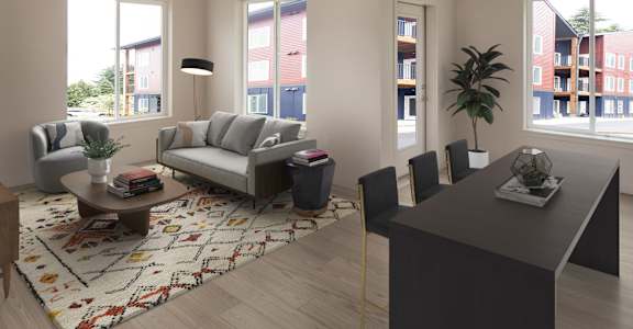 A living room with a grey sofa, a black chair, a coffee table, and a rug with a pattern.