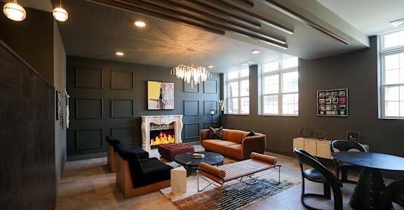 A modern living room with a fireplace and a dining table. at 1010 Apartments, Allentown, 18101