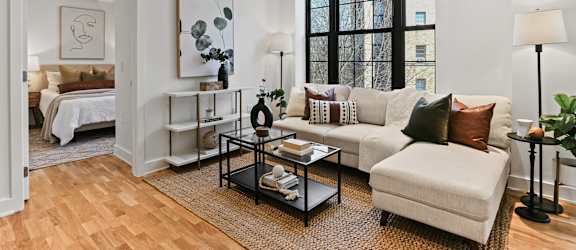 A living room with a white couch and a coffee table.