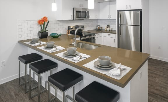 Arc Central Apartments Model Kitchen with Appliances and Breakfast Bar
