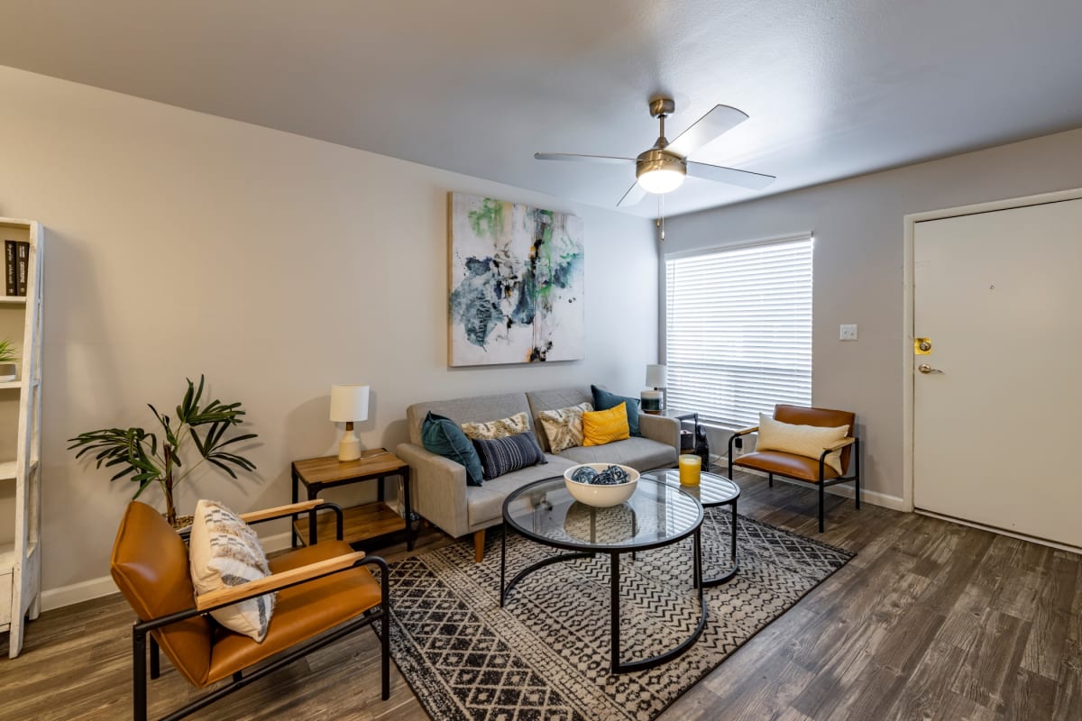 Furnished living room with wood-look flooring — view 1 at Arches Apartment Homes.