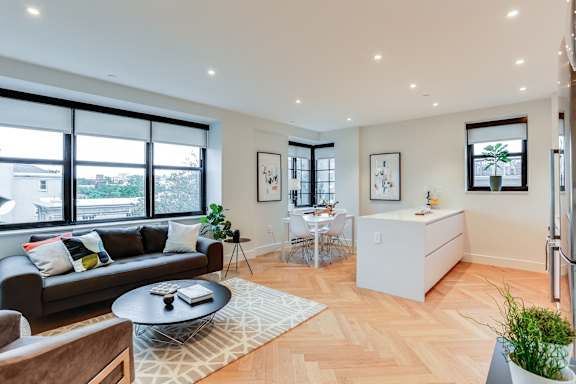 Open concept living and dining rooms with brand new hardwood flooring