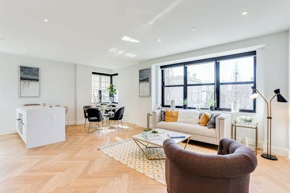 Open living and dining concept with lots of natural light, hardwood floors and Nest temperature control system.
